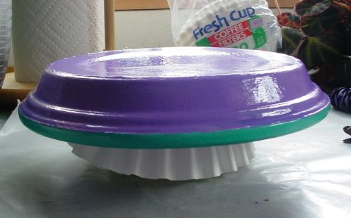 Coffee filters between the saucer and the butter tub add a cusion that protects the paint from getting marred.