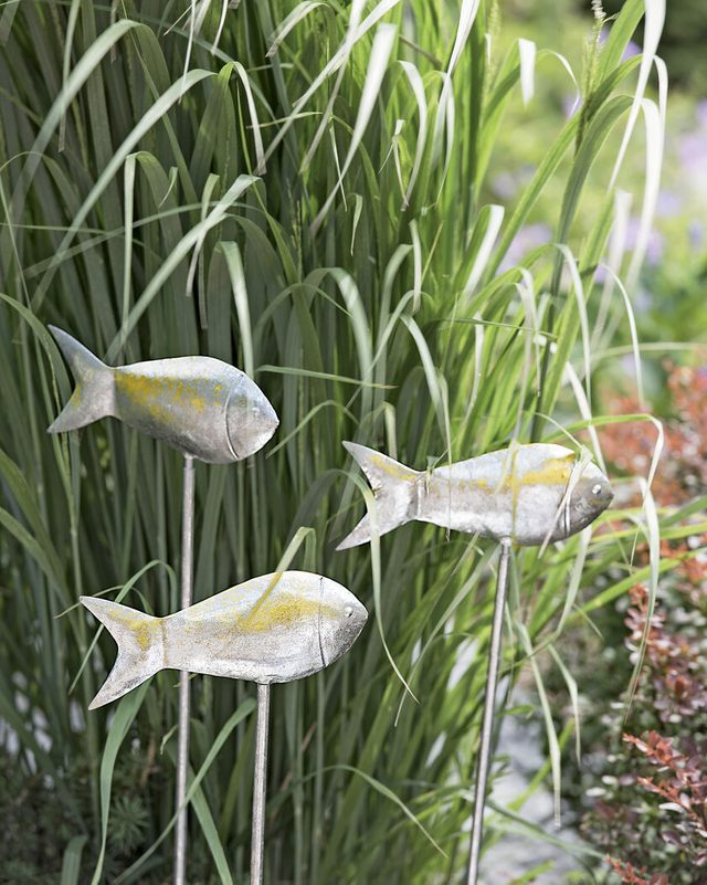Fish garden stakes in grass