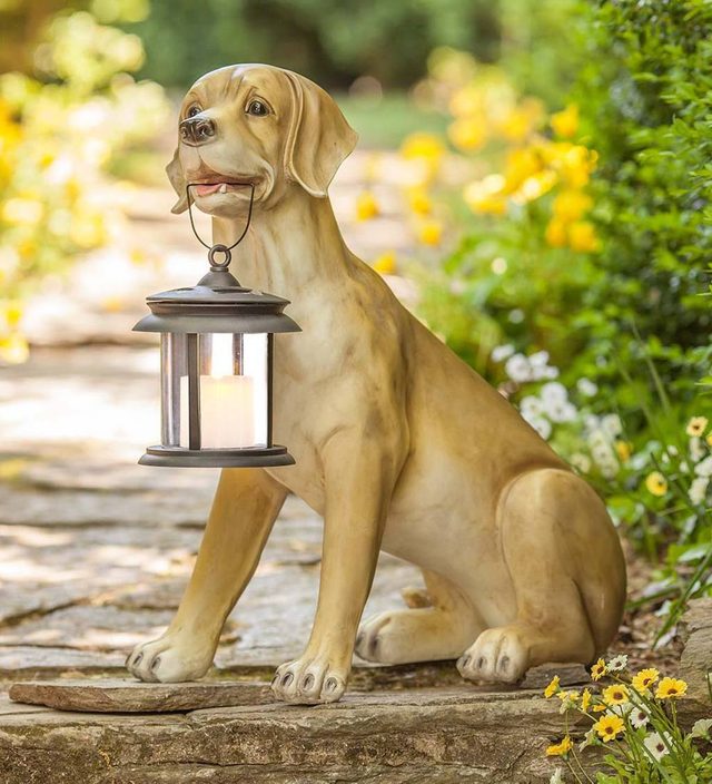 Yellow Labrador sculpture holding a solar lantern