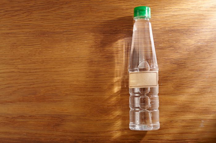 top view of white vinegar on the wooden background