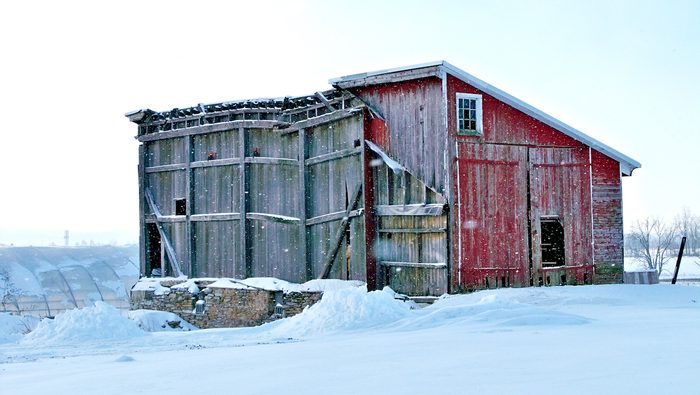 And old barn structure in the snow.