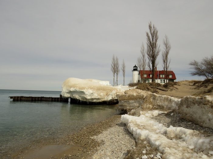 Winter scene of Fort Betsie lighthouse on the shores of Lake Michigan.