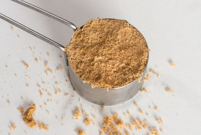 High Angle View Of Brown Sugar In Measuring Cup