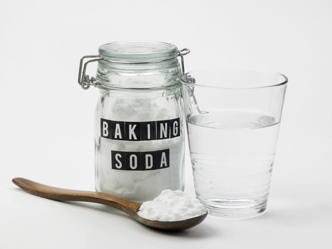 Close-Up Of Baking Soda With Drinking Water On White Background