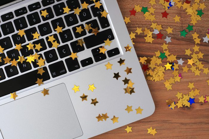 laptop keyboard with yellow stars confetti to celebrate amazon prime day