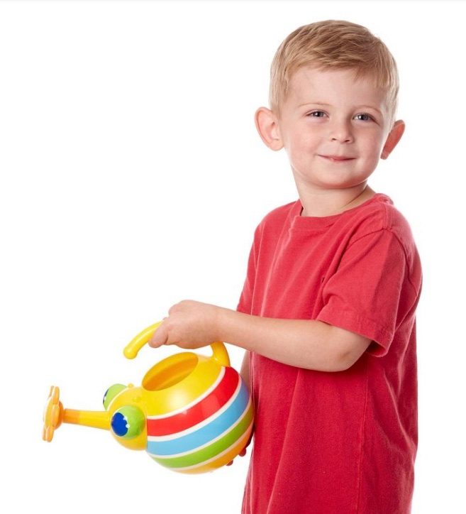 A child holding a colorful toy watering can that resembles a bug.