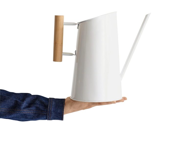 A modern-looking white metal watering can with a wooden handle.